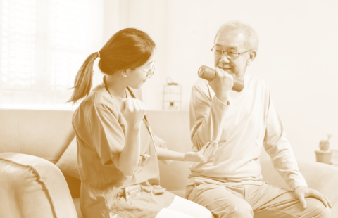 caregiver assisting senior on his exercise